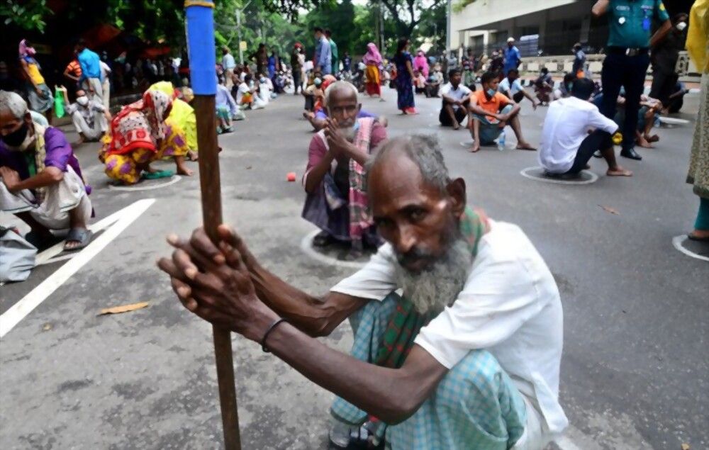 Poor people queue sit waits for receive food